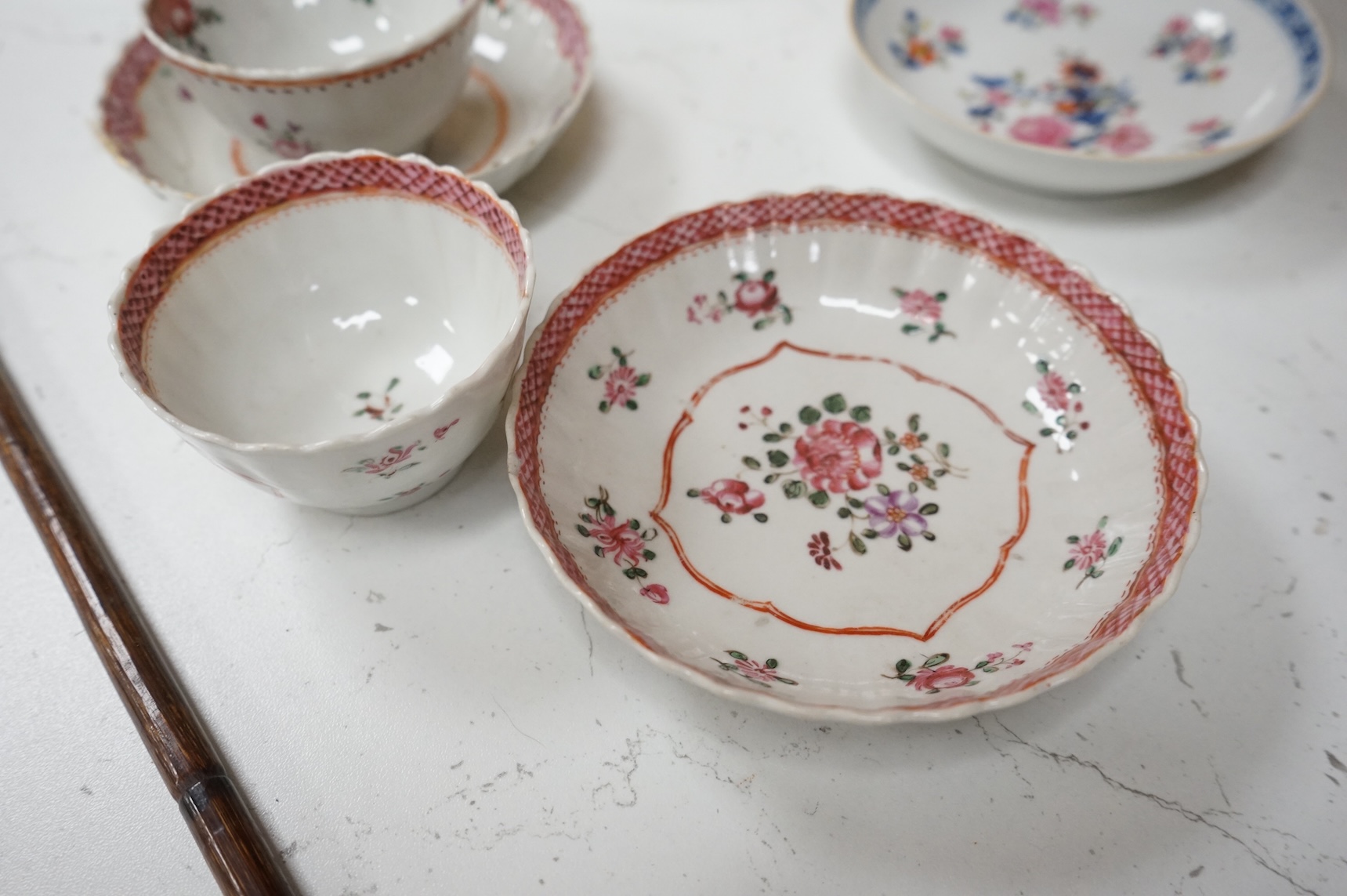 A collection of 18th century Chinese export and English porcelain to include tea bowls and saucers, largest saucer 14cm in diameter